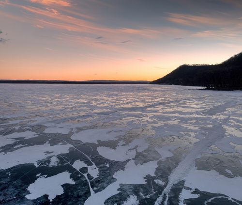Free Tranquil winter sunset over a frozen lake at Camp Lacupolis, Minnesota. Stock Photo