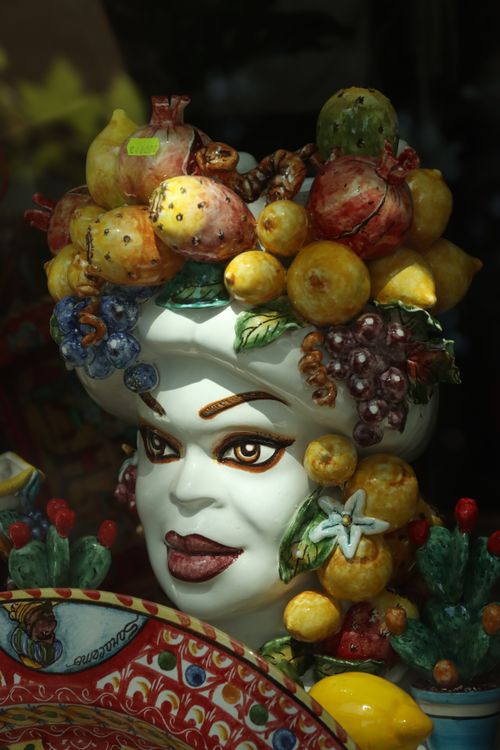 Free Vibrant ceramic bust adorned with a variety of colorful fruits. Stock Photo