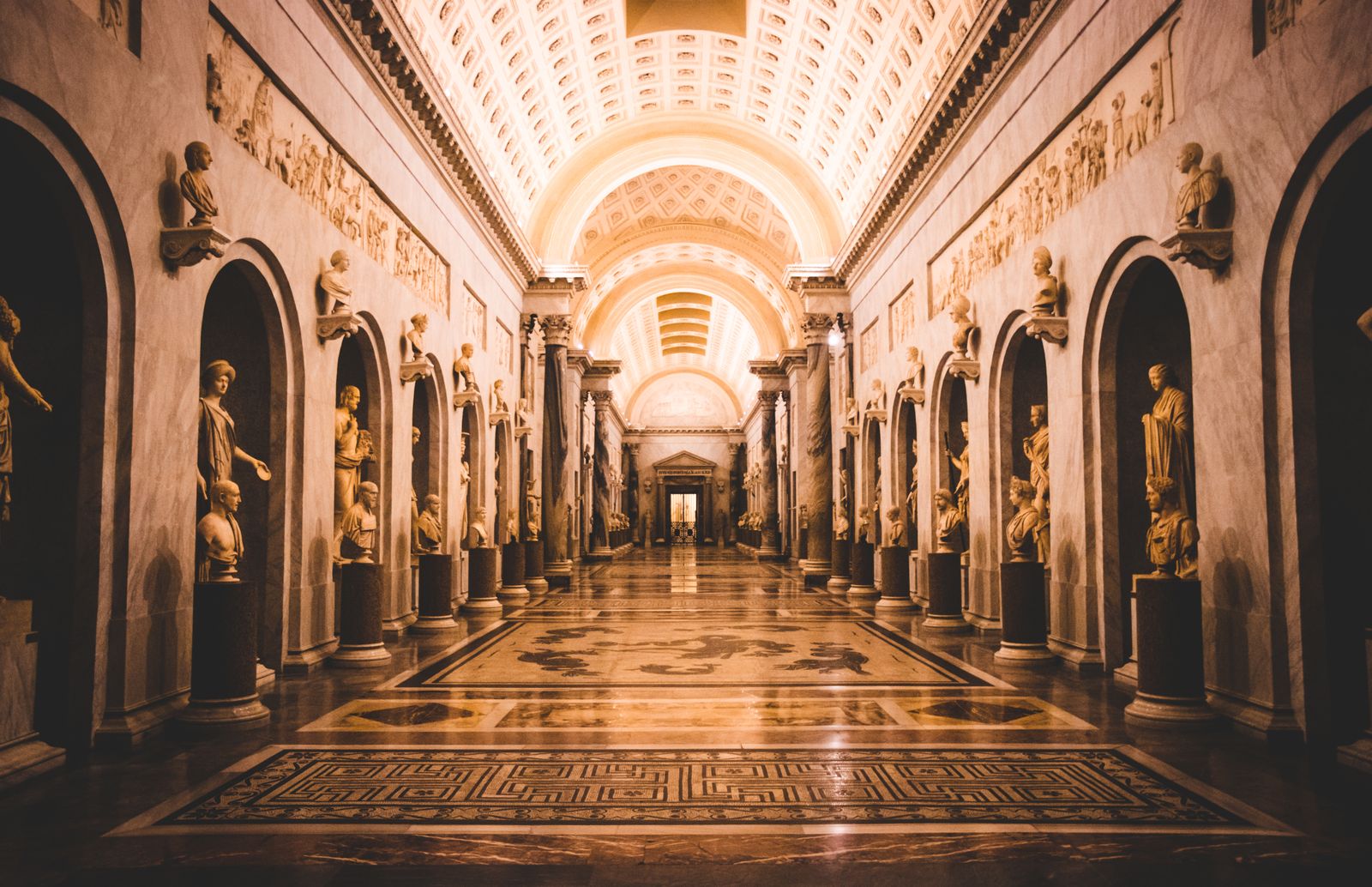Paintings lining a long gallery corridor