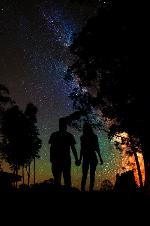 Silhouette of Man and Woman Holding Hands