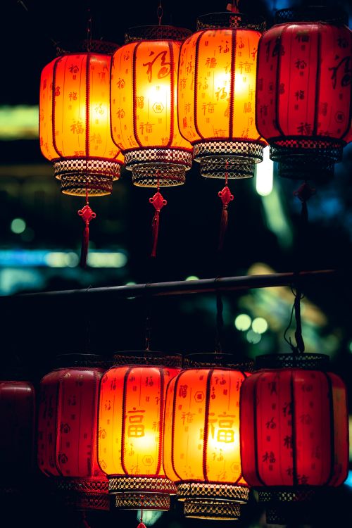Free Glowing red Chinese lanterns hanging outdoors at night, creating a vibrant atmosphere. Stock Photo