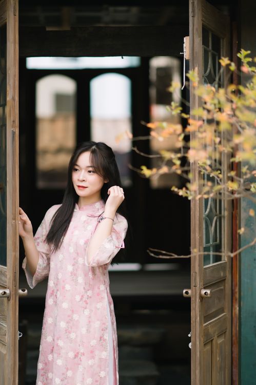 Young Woman in Floral Dress at Traditional Doorway · Free Stock Photo