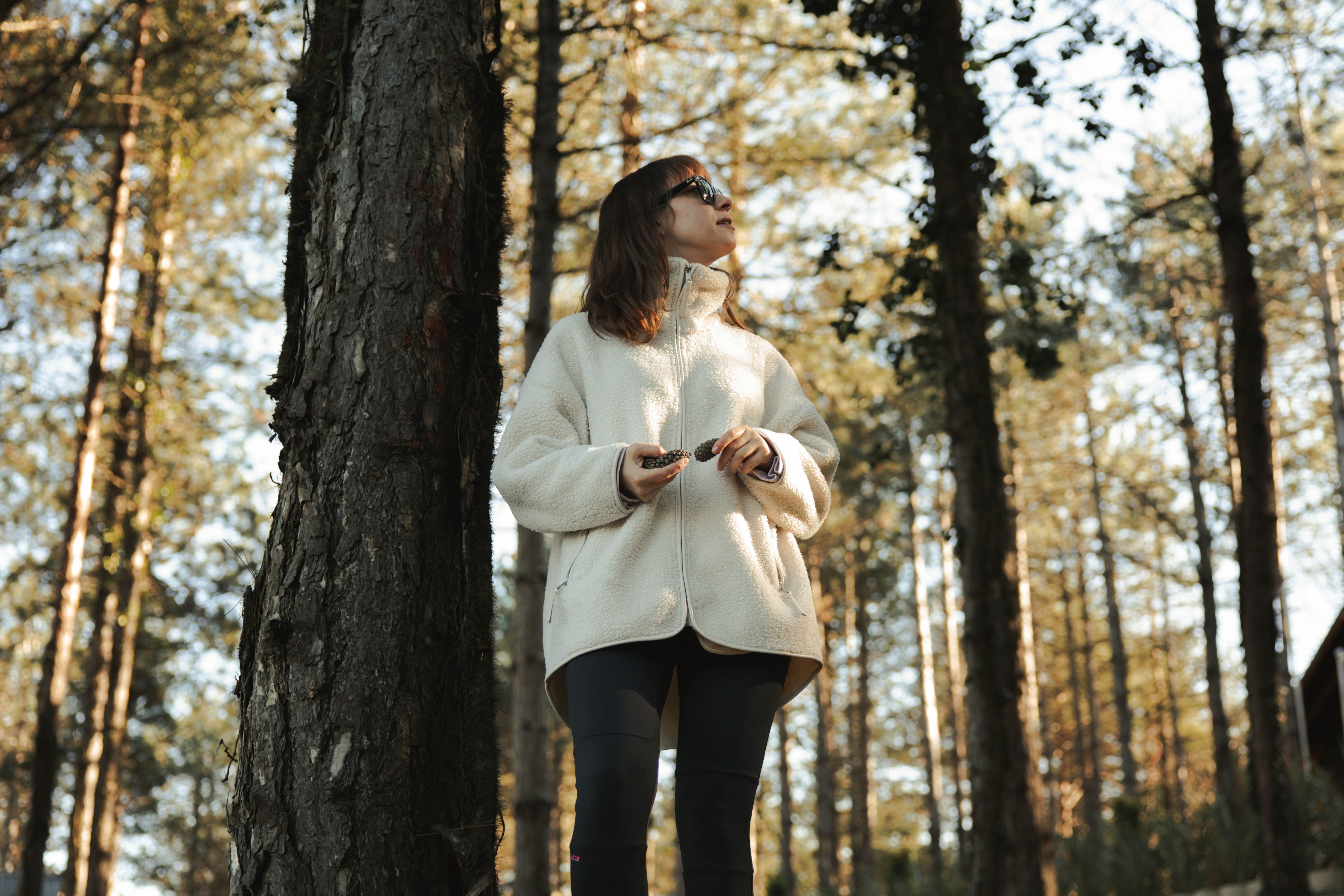 A woman enjoying a peaceful walk in the forest of Sapanca, Türkiye, during a sunny day.
