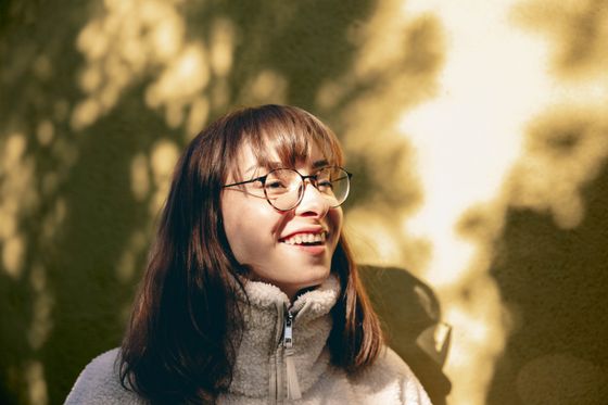 Young woman laughing in afternoon sunlight — photo by Büşranur Aydın on Pexels
