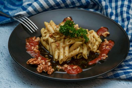 Enjoy a classic Italian pasta dish with penne, herbs, and a touch of tomato sauce.