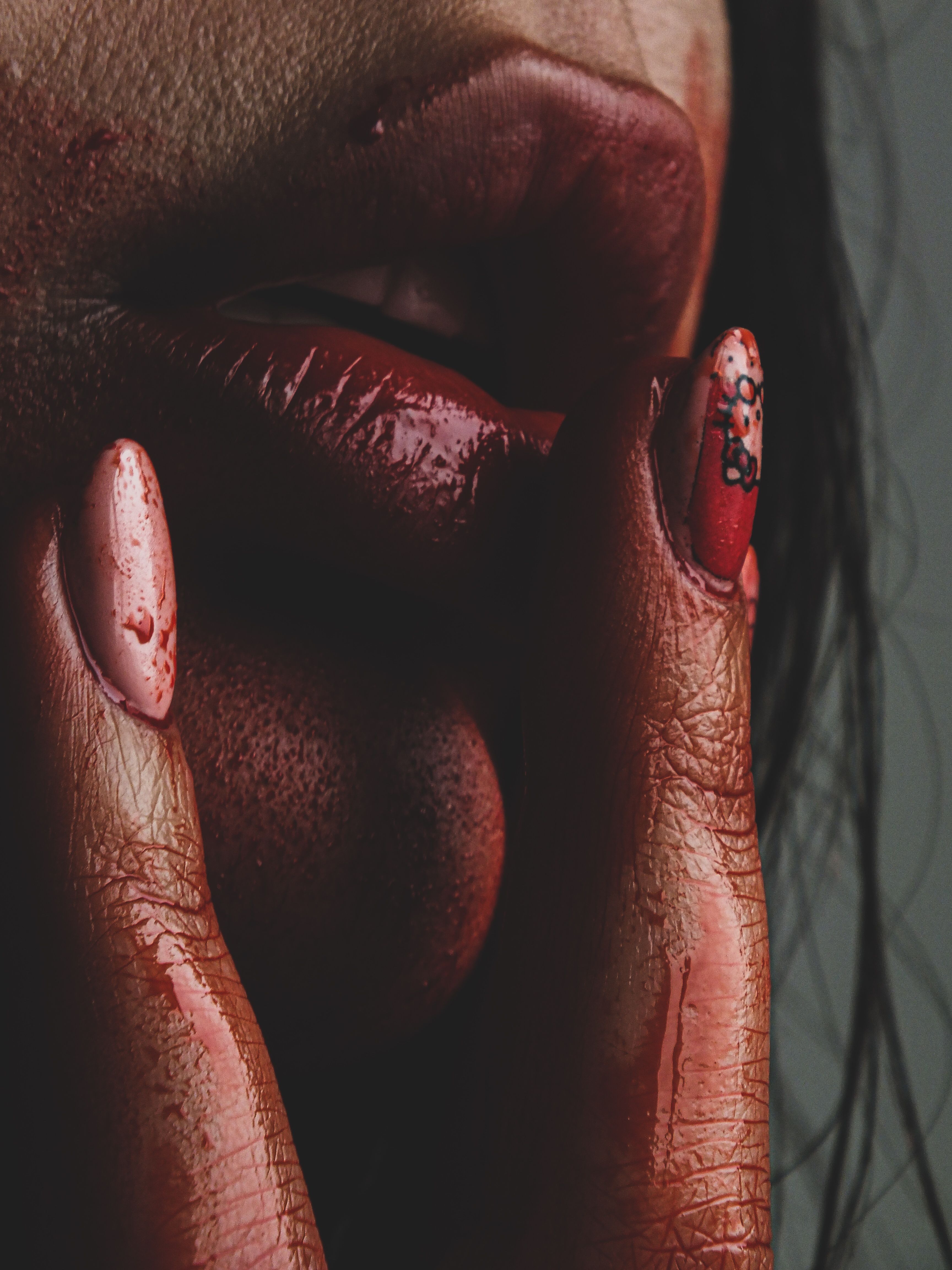 Dramatic Close-Up of Painted Lips and Nails · Free Stock Photo