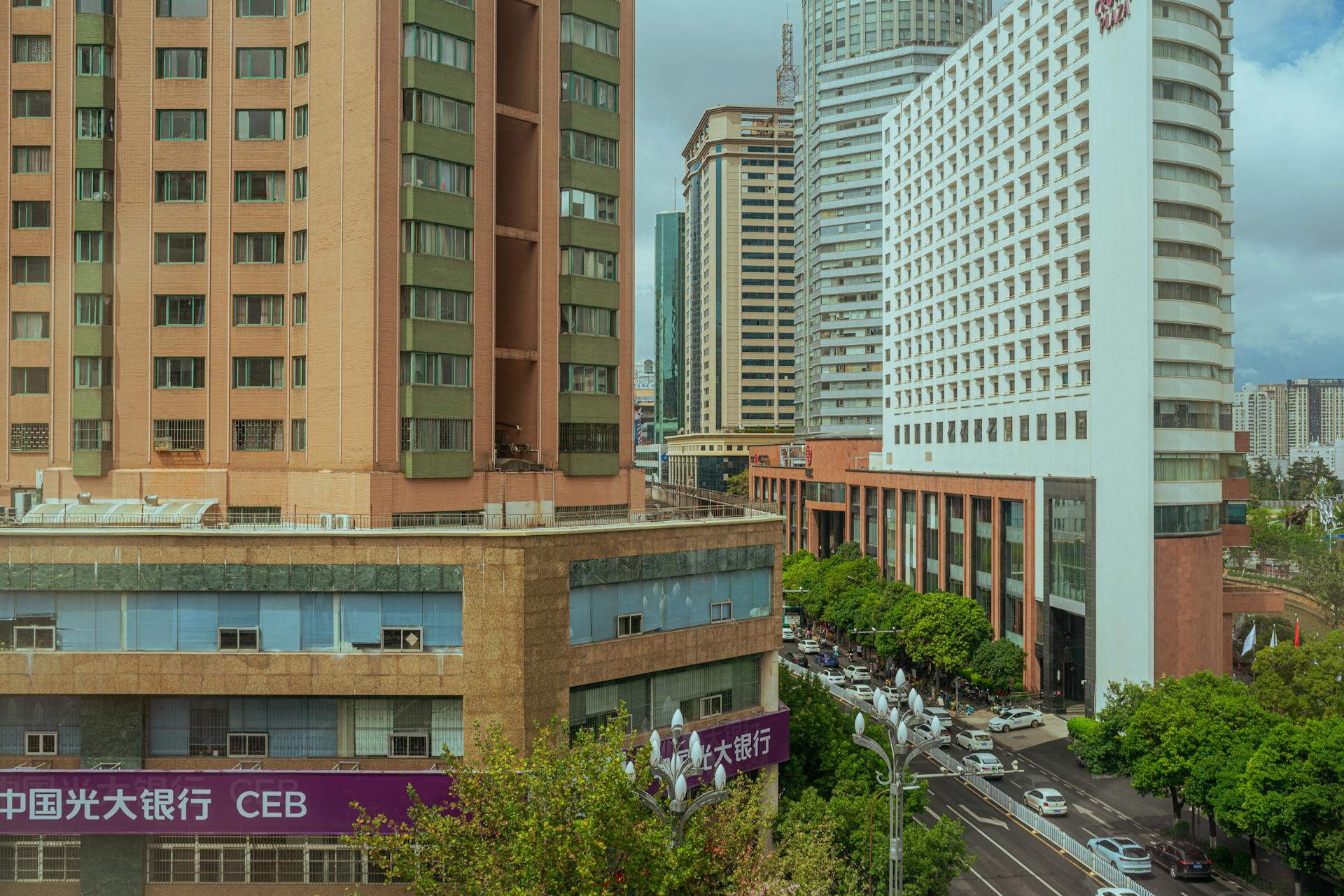 Panoramic view of a busy city street lined with modern high-rise buildings.