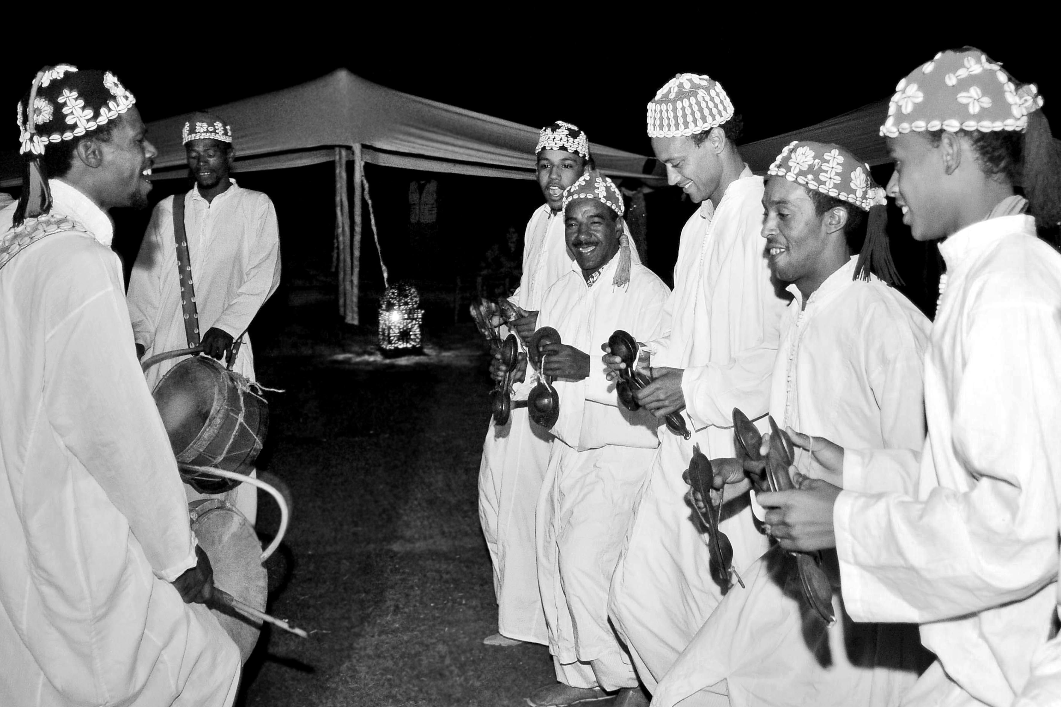Is Marrakech Safe for Tourists? (Honest Guide) - Moroccan Gnawa musicians perform at night with traditional instruments in Marrakech. - Marrakech