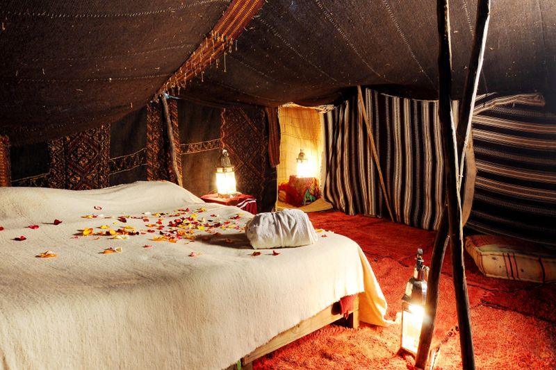 Suite Fatiha — Moroccan bedroom with textiles and lanterns