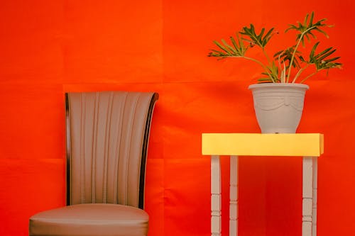 Brown Leather Chair and Beige Pot on Yellow and White Wooden Table