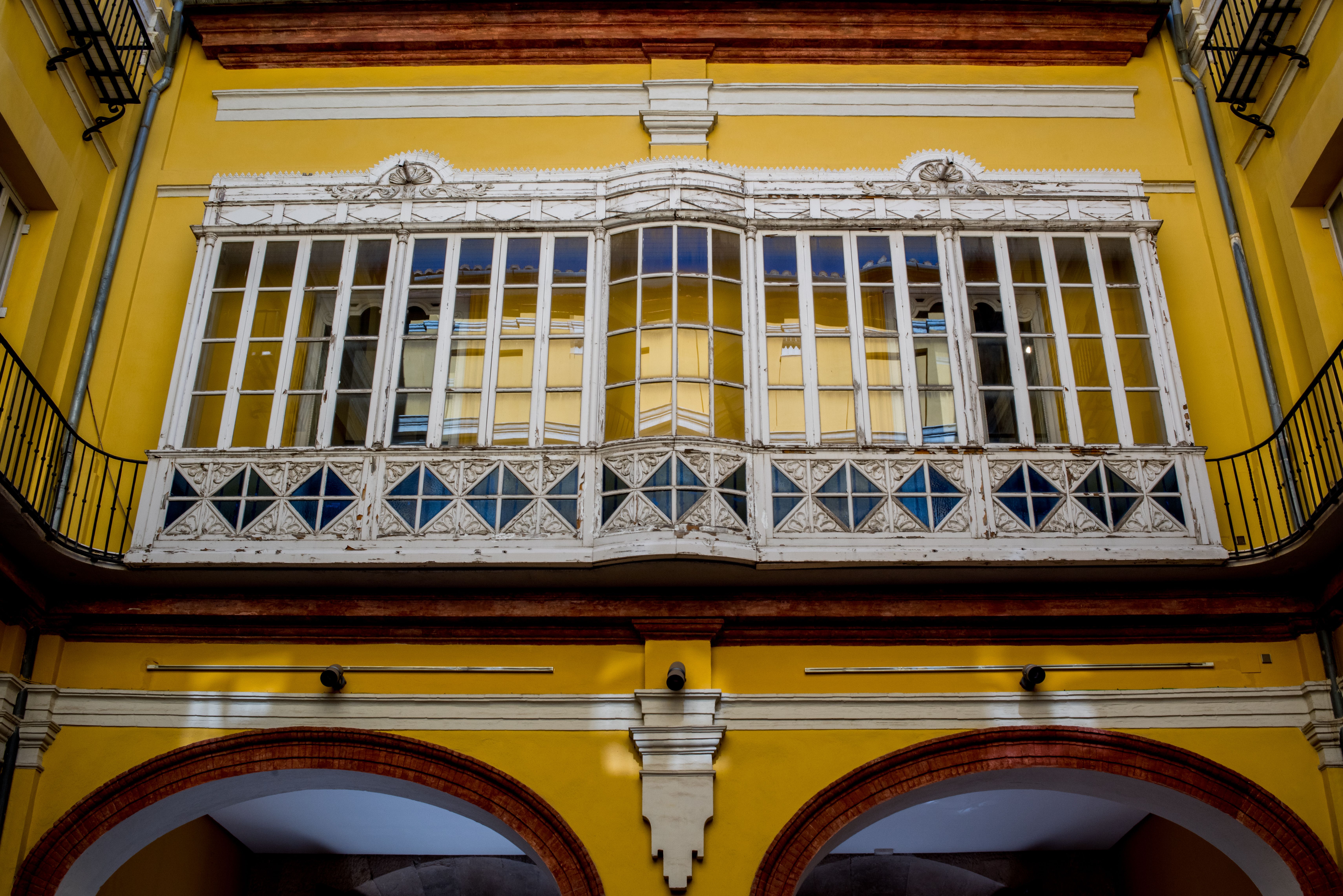 Yellow Building Facade with Ornate Windows · Free Stock Photo