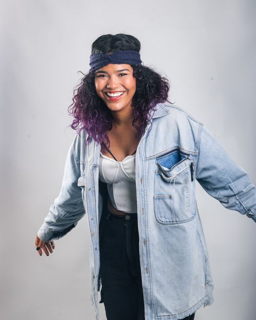 Free Happy young woman posing in a casual denim outfit indoors. Stock Photo