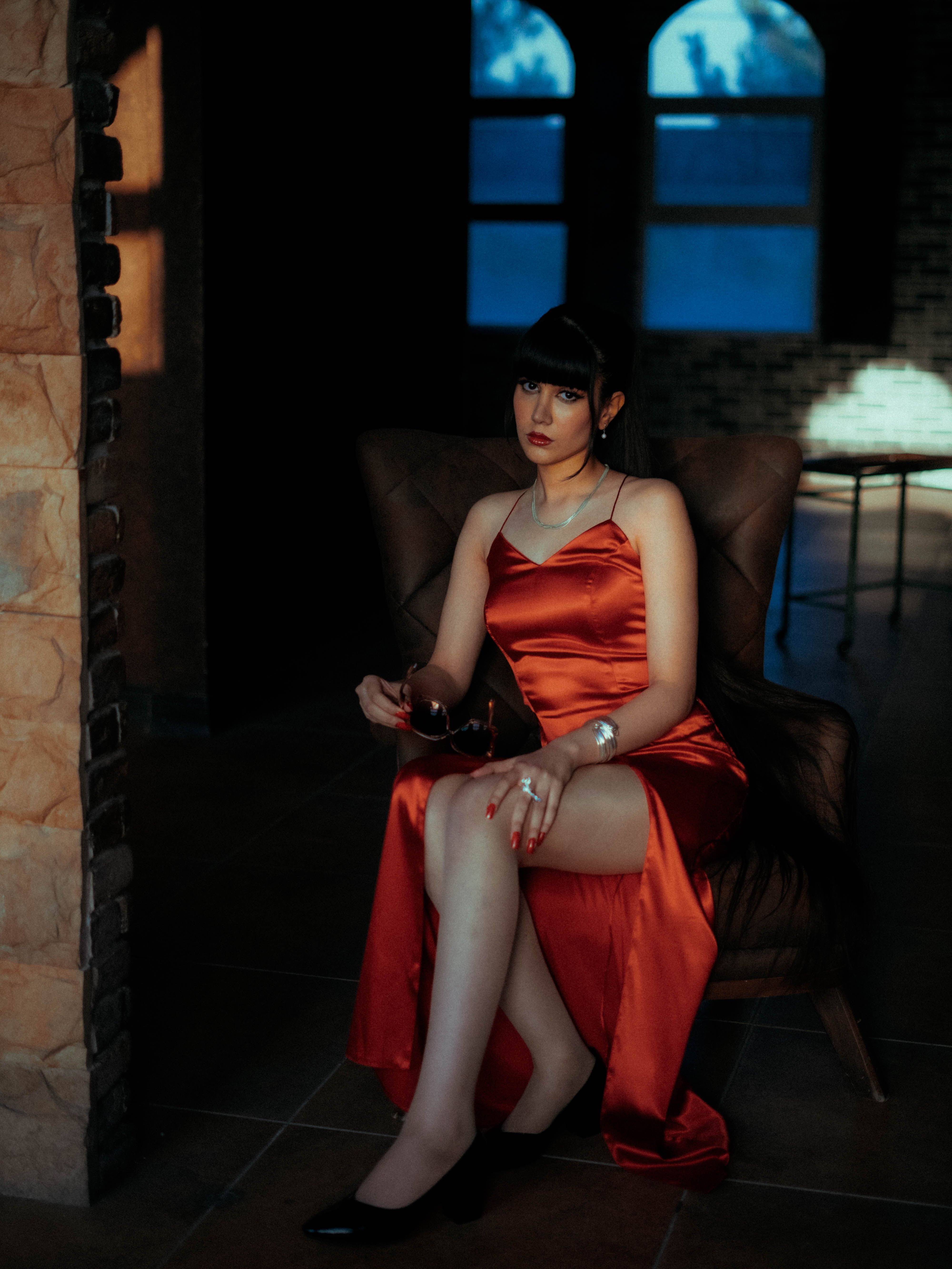 Woman wearing a red satin slip dress for date night