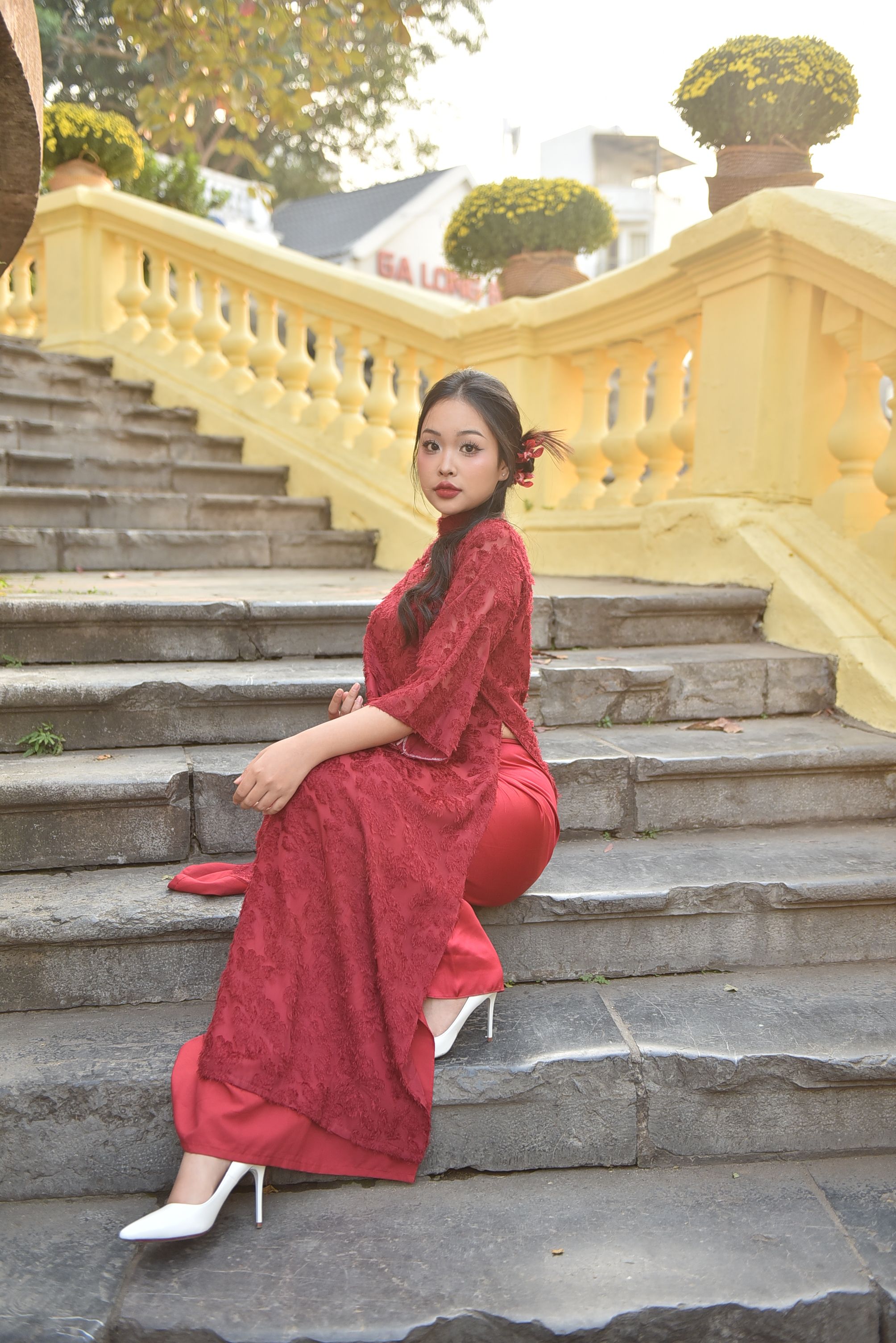 Young Woman in Traditional Red Dress on Stone Steps · Free Stock Photo