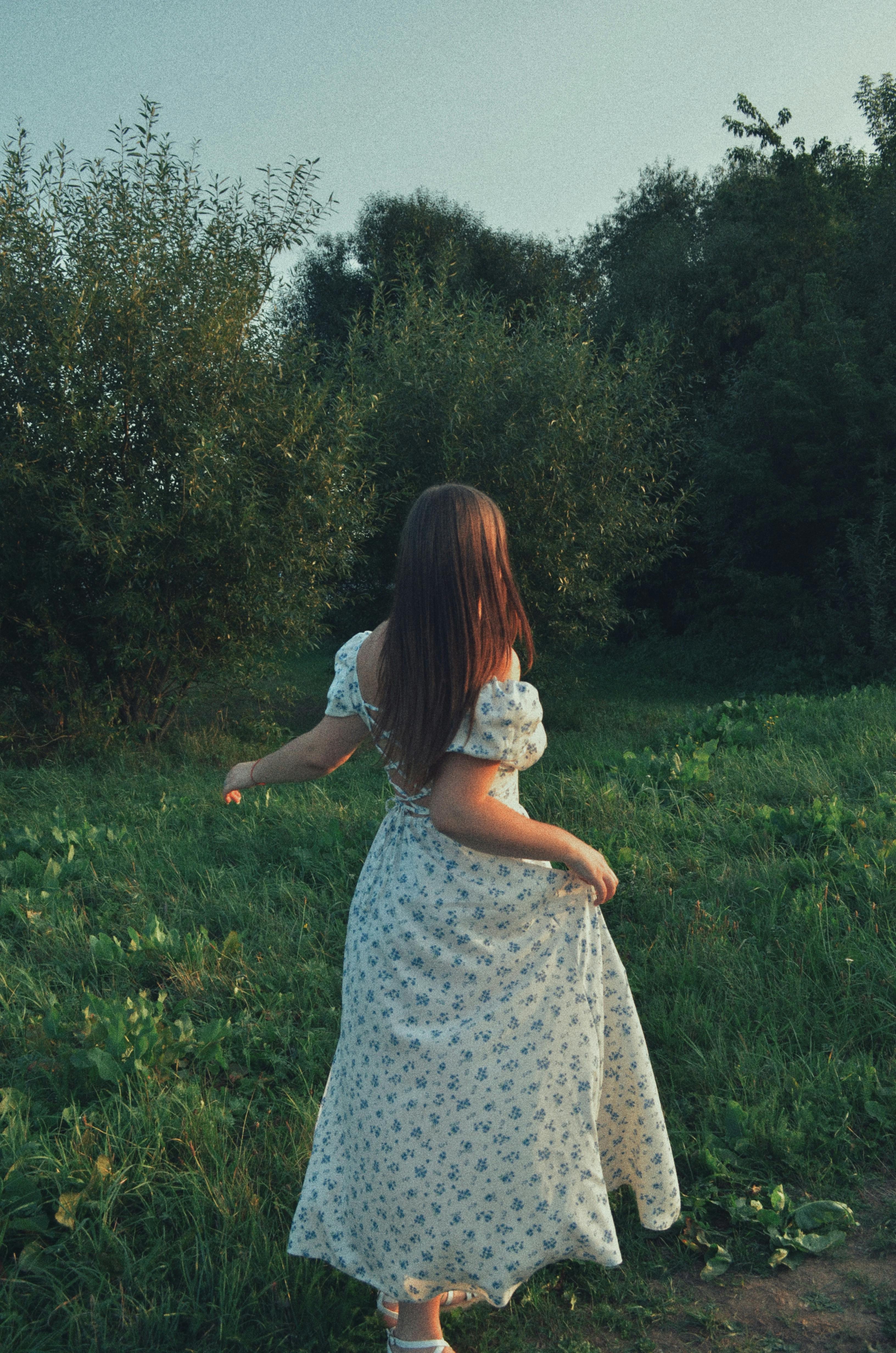 A floral dress in a lush summer landscape — the heart of the trend.