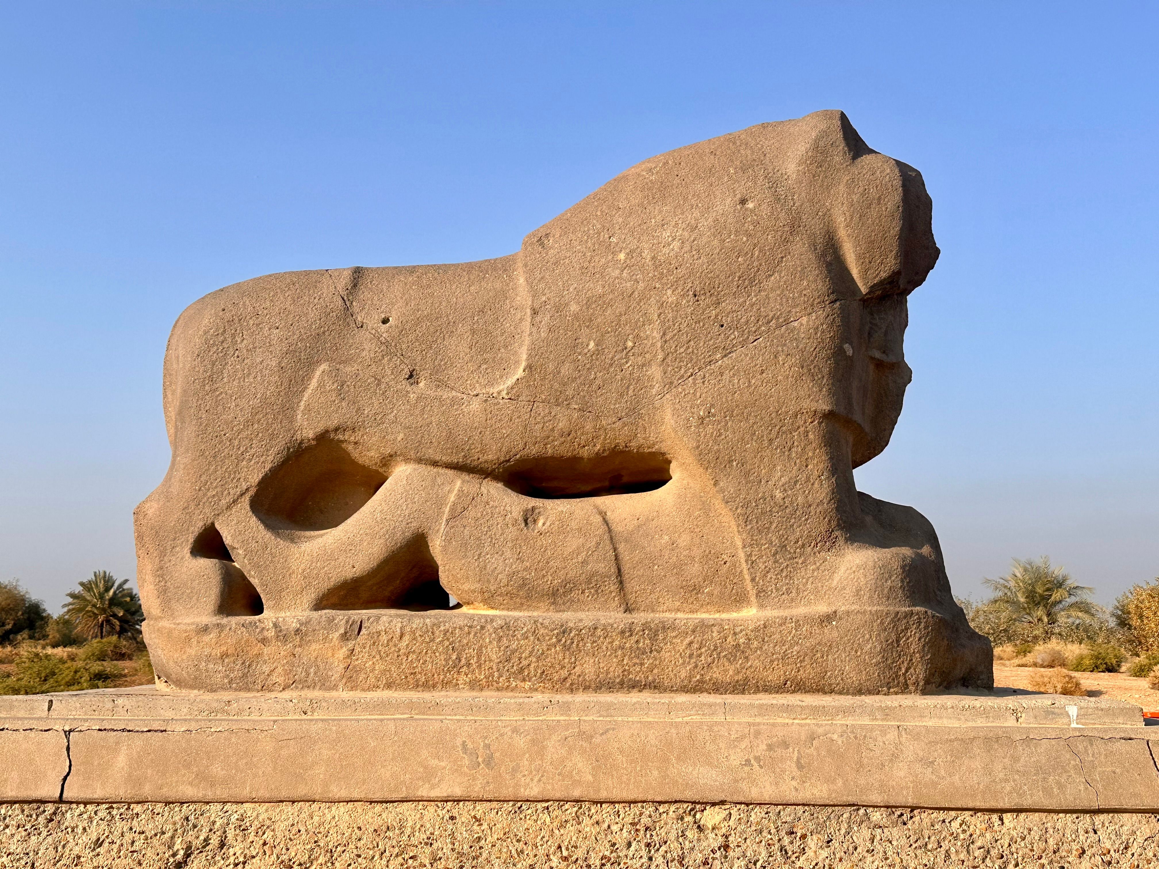 Discover the historical stone lion sculpture under the clear sky of Iraq.