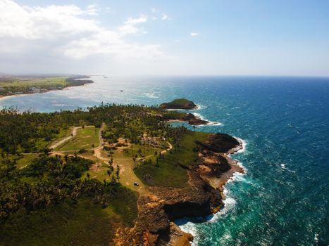 Stunning aerial shot of a tropical coastline with clear blue waters and lush greenery.