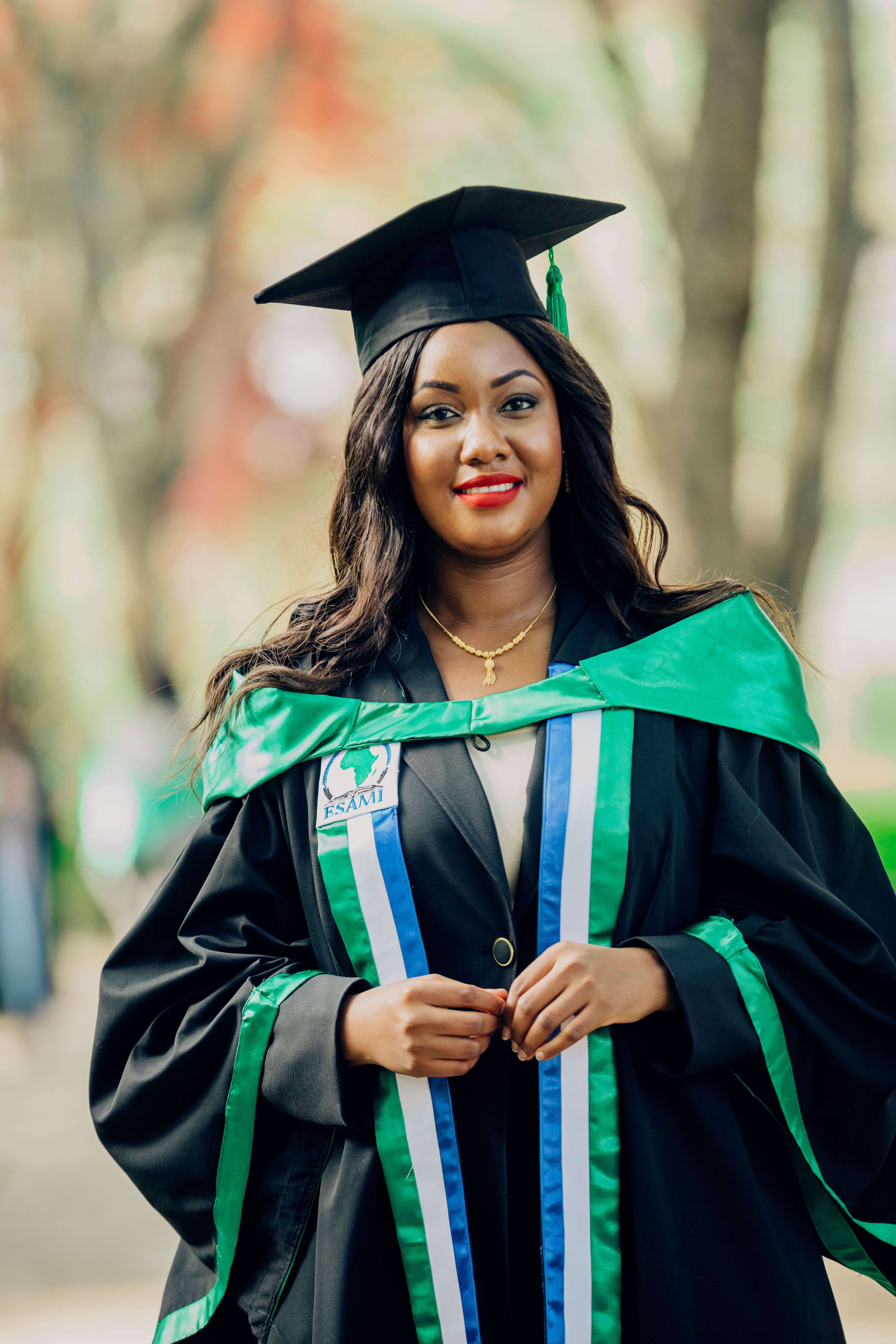 Young Woman Graduate in Cap and Gown Outdoors · Free Stock Photo