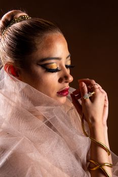 Close-up of a woman adorned with snake-inspired jewelry, exuding elegance.