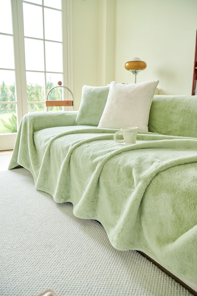 Elegant living room with plush green sofa cover