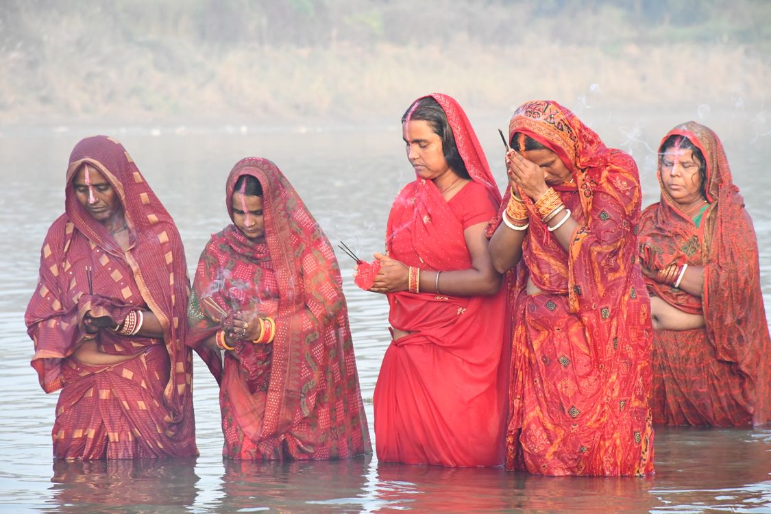 Women Performing Traditional Rituals in River · Free Stock Photo