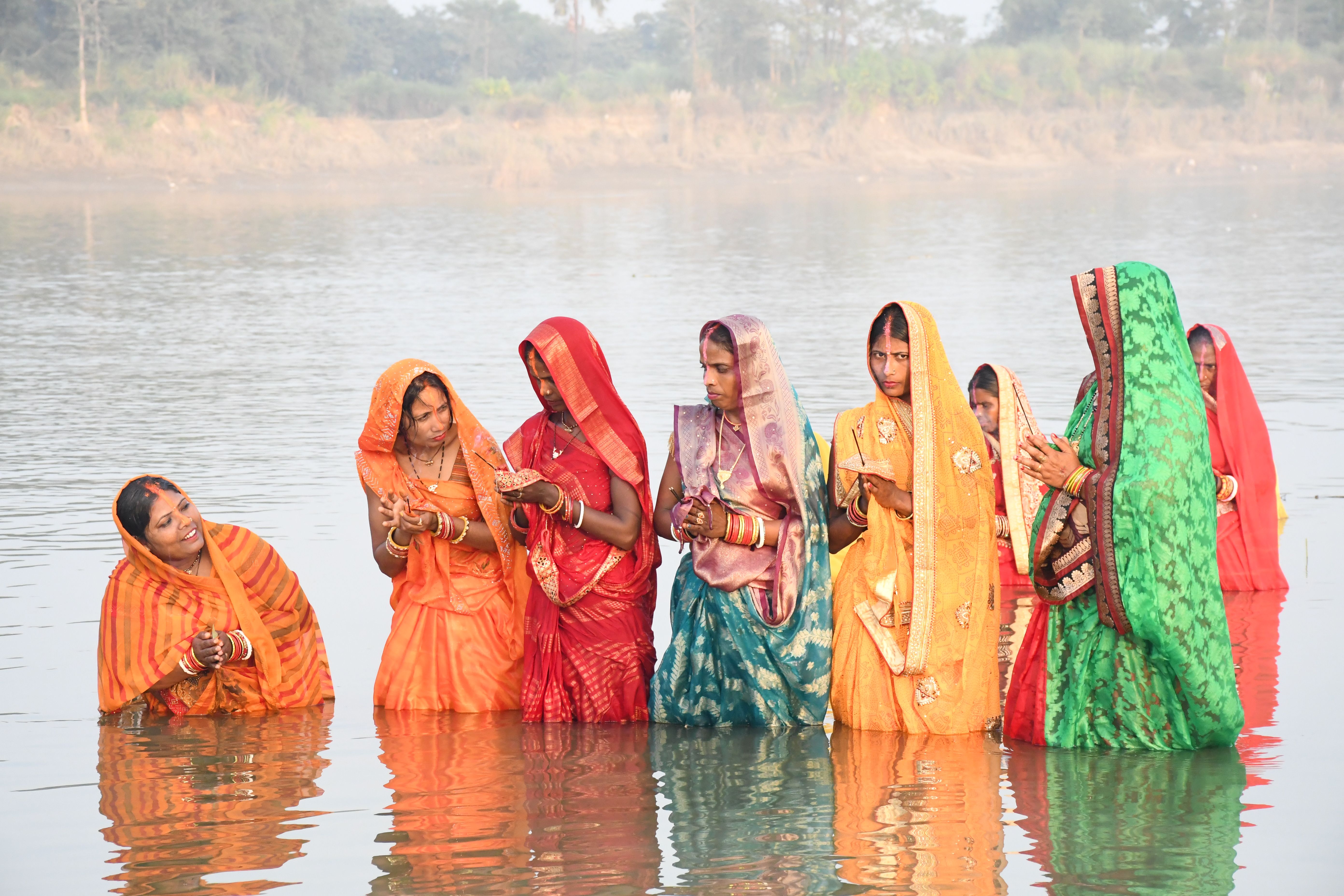 Women in Traditional Saris Performing Ritual in River · Free Stock Photo