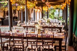 A long outdoor table under bistro lights