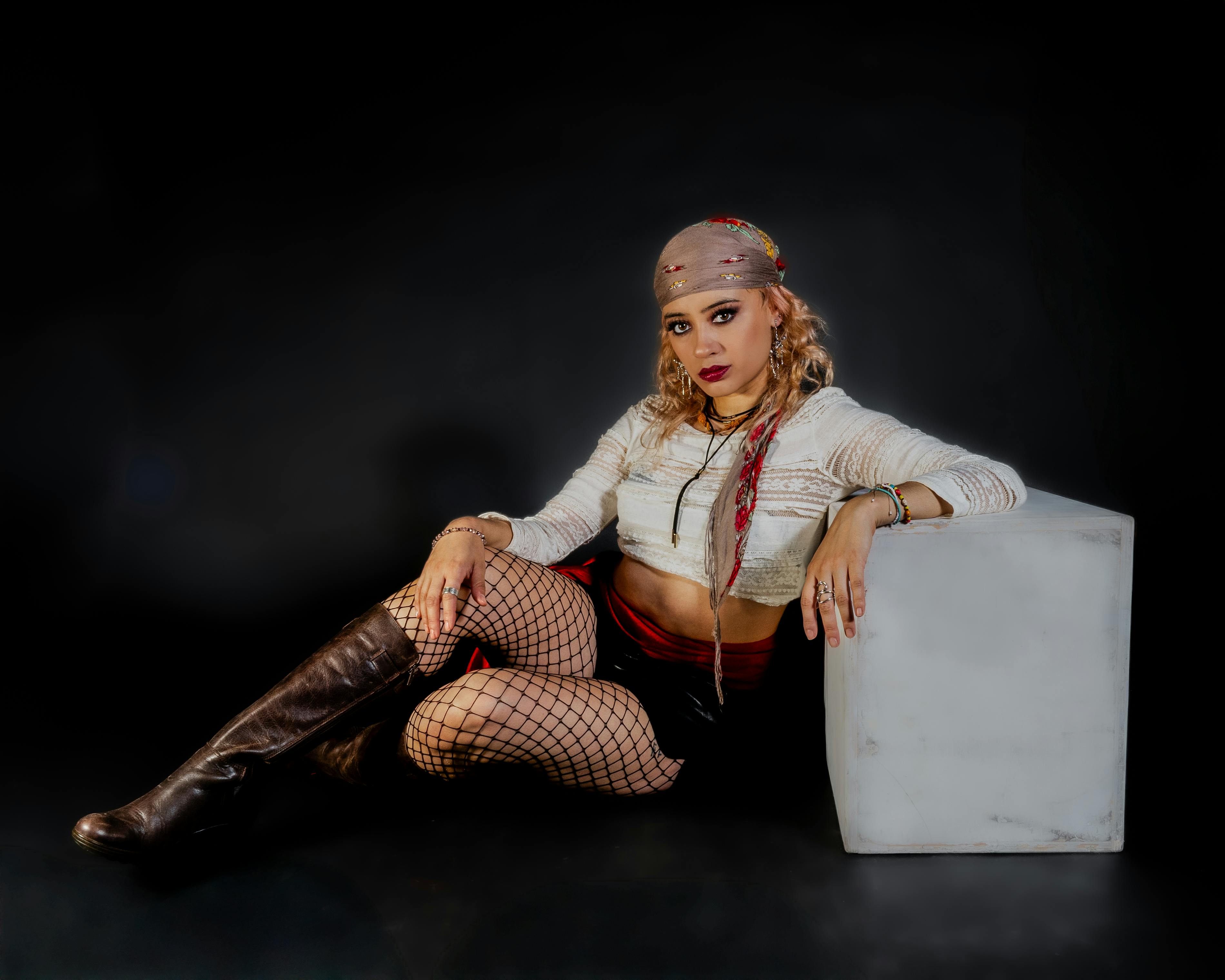 stylish woman in edgy fashion pose on black background