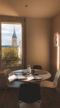 Cozy interior with a view of Normandy church spire through the window.