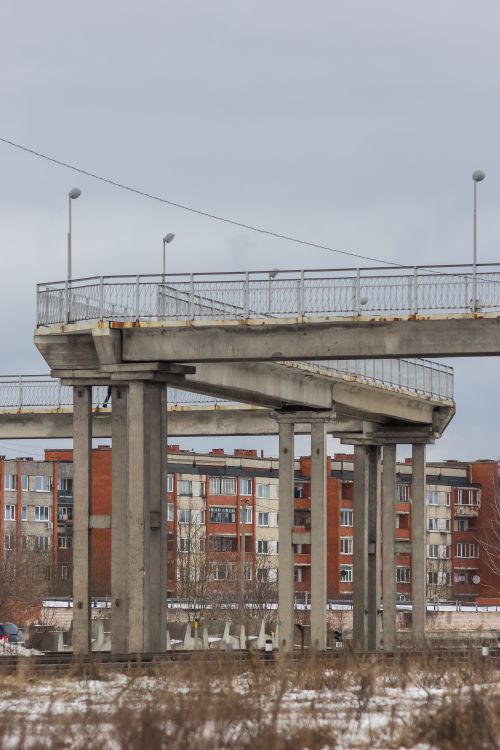 Free An unfinished urban overpass with residential buildings in the background. Stock Photo