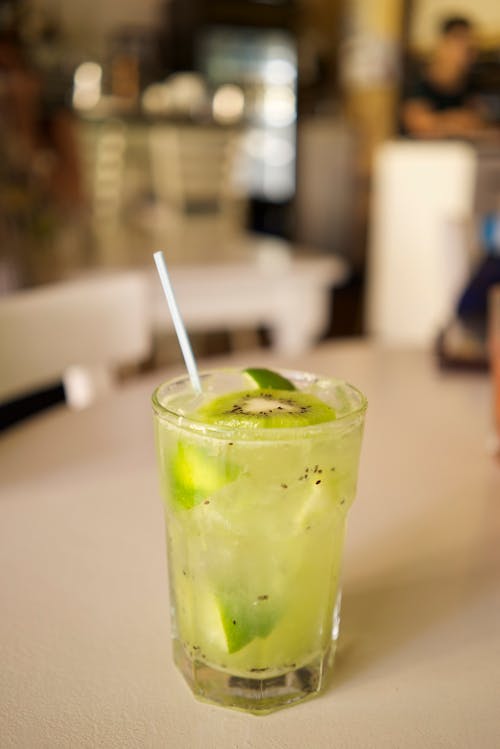 A Glass Filled With Refreshing Juice Drink With Lime And Kiwi