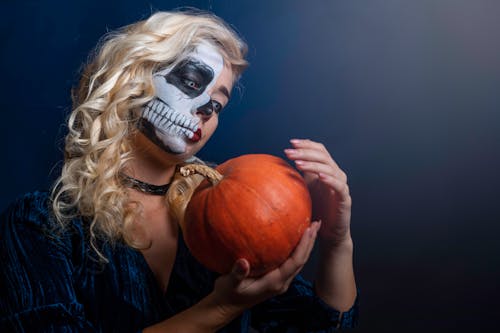 Free Woman With Face Paint With Pumpkin Stock Photo