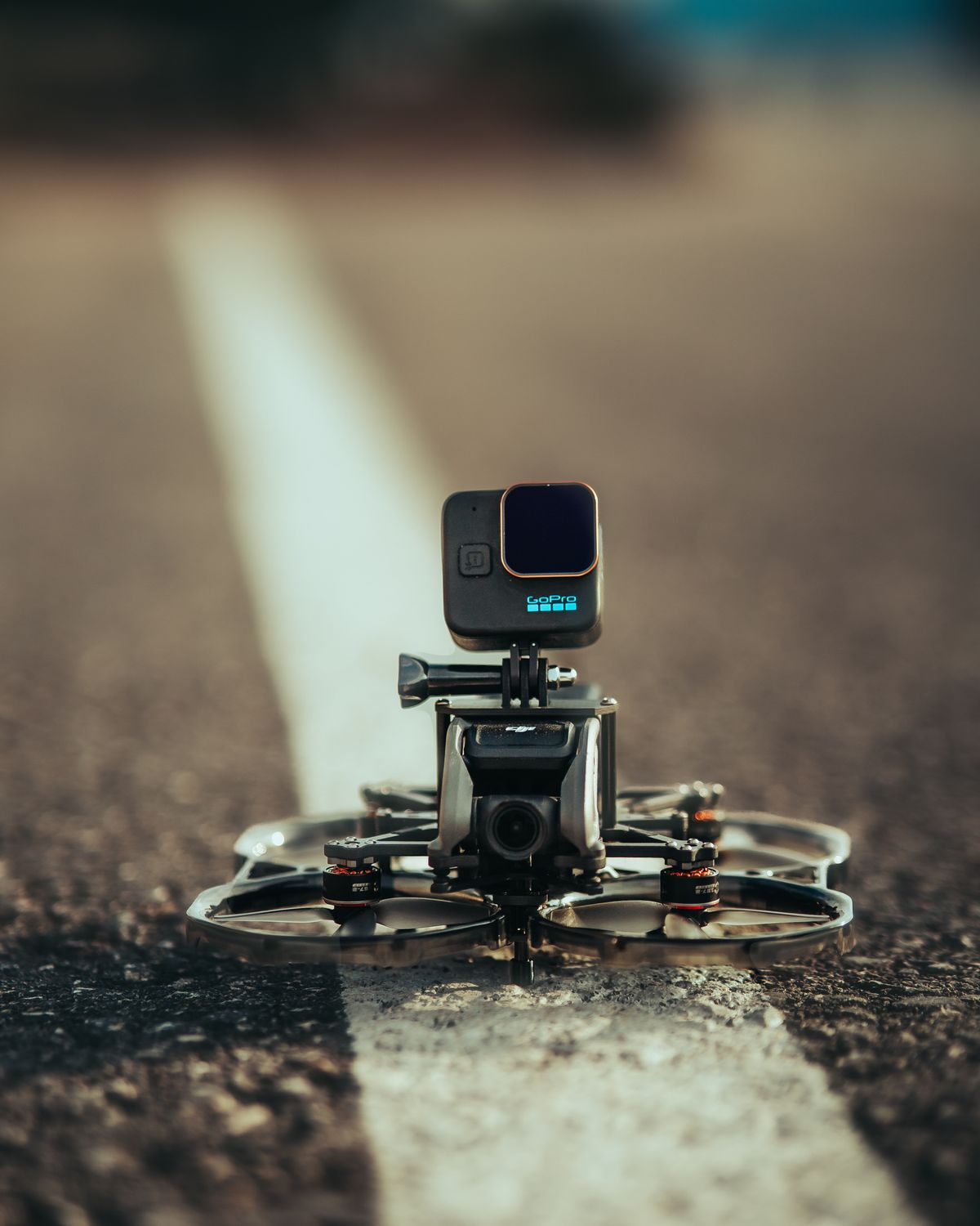 FPV drone with an action camera on an outdoor surface