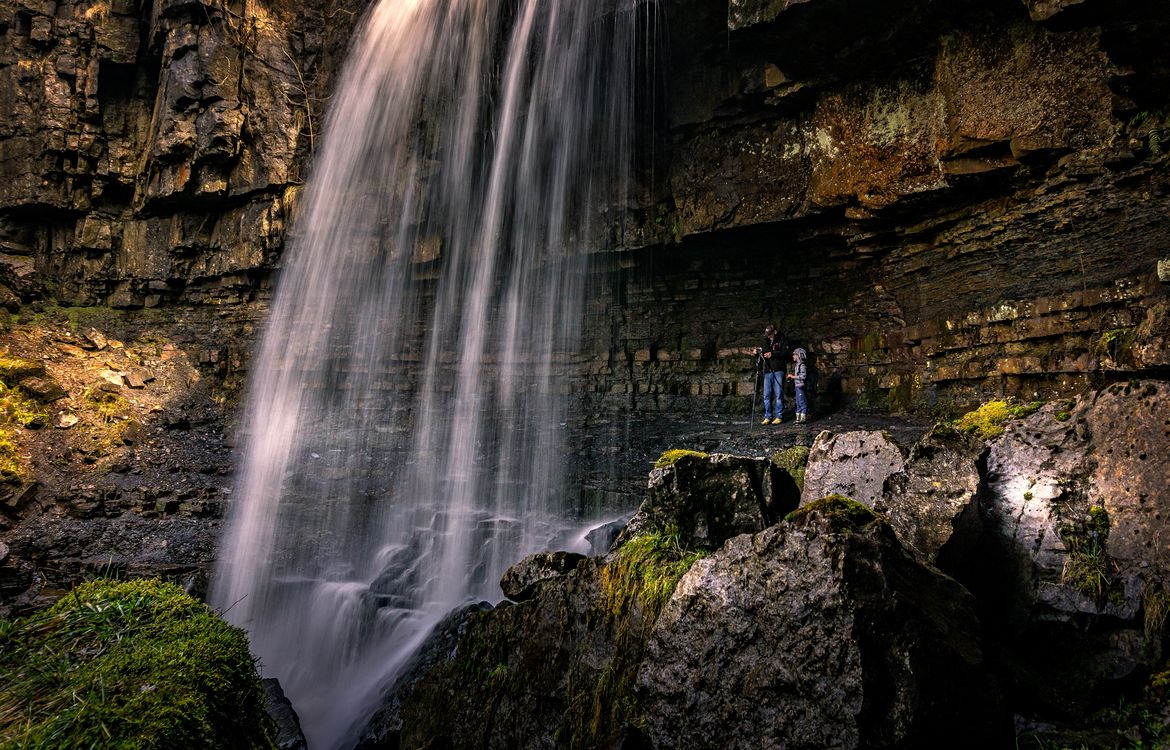 Explor Waterfall Majestic Waterfall with Visitors Exploring Rocks · Free Stock Photo