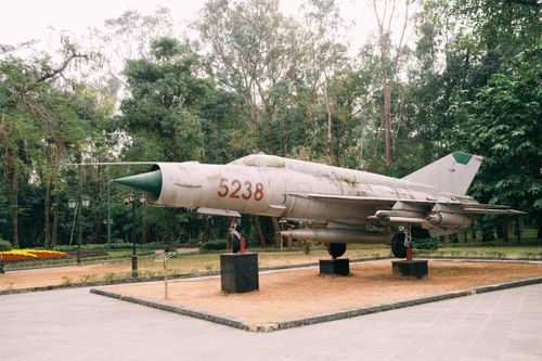Free Old military jet fighter on display in a lush green park. Stock Photo