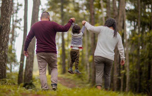 Free Man and Woman Carrying Toddler Stock Photo