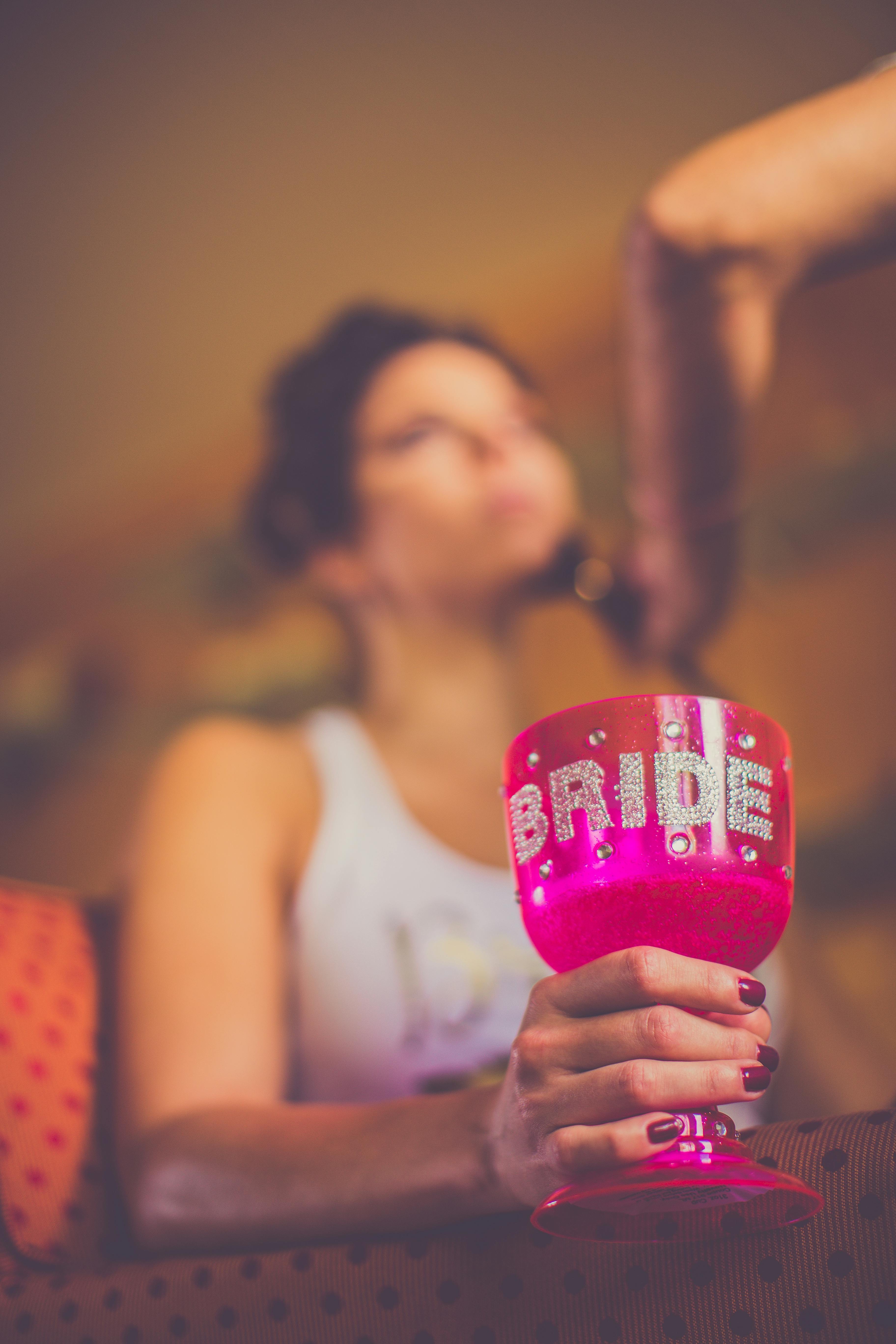 Bride holding a pink 'Bride' goblet during a leisure gathering, showcasing celebration vibes.