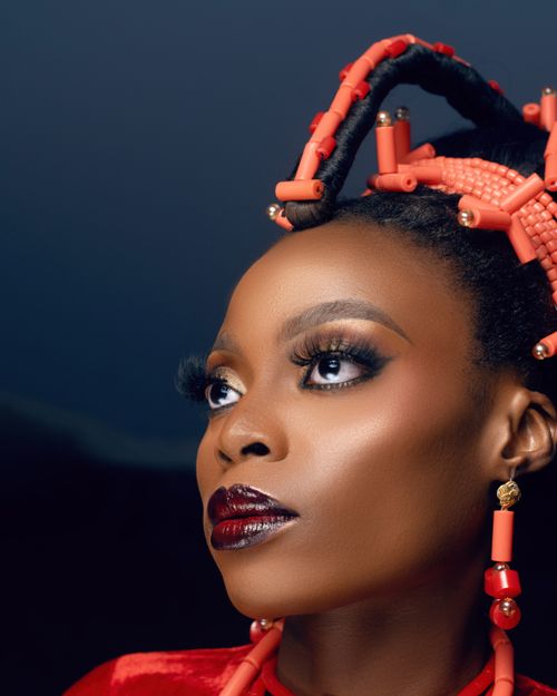 Free Elegant portrait capturing a woman in traditional African attire and makeup. Rich cultural essence. Stock Photo