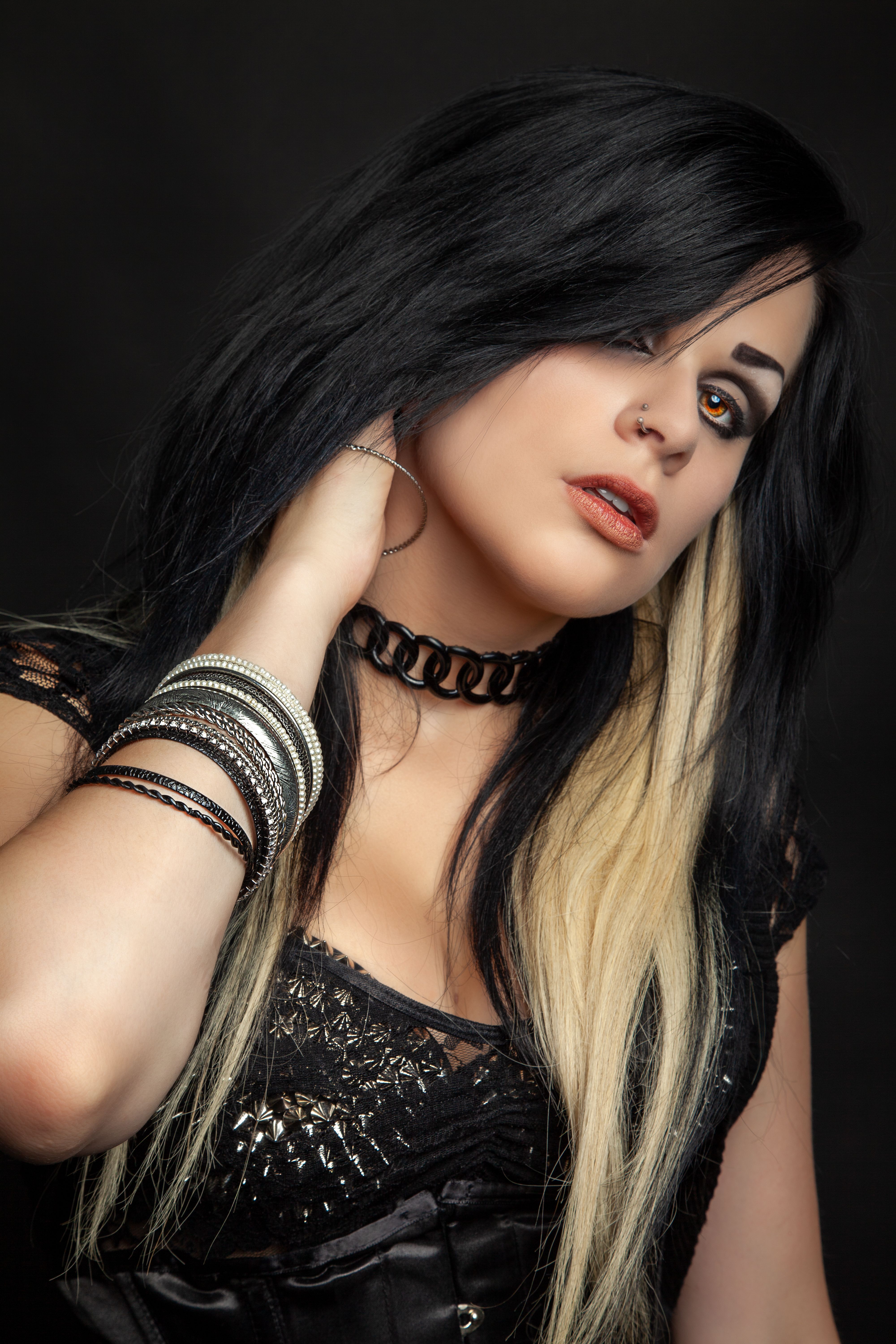 Portrait of a woman in gothic style with striking jewelry, showcasing bold fashion.