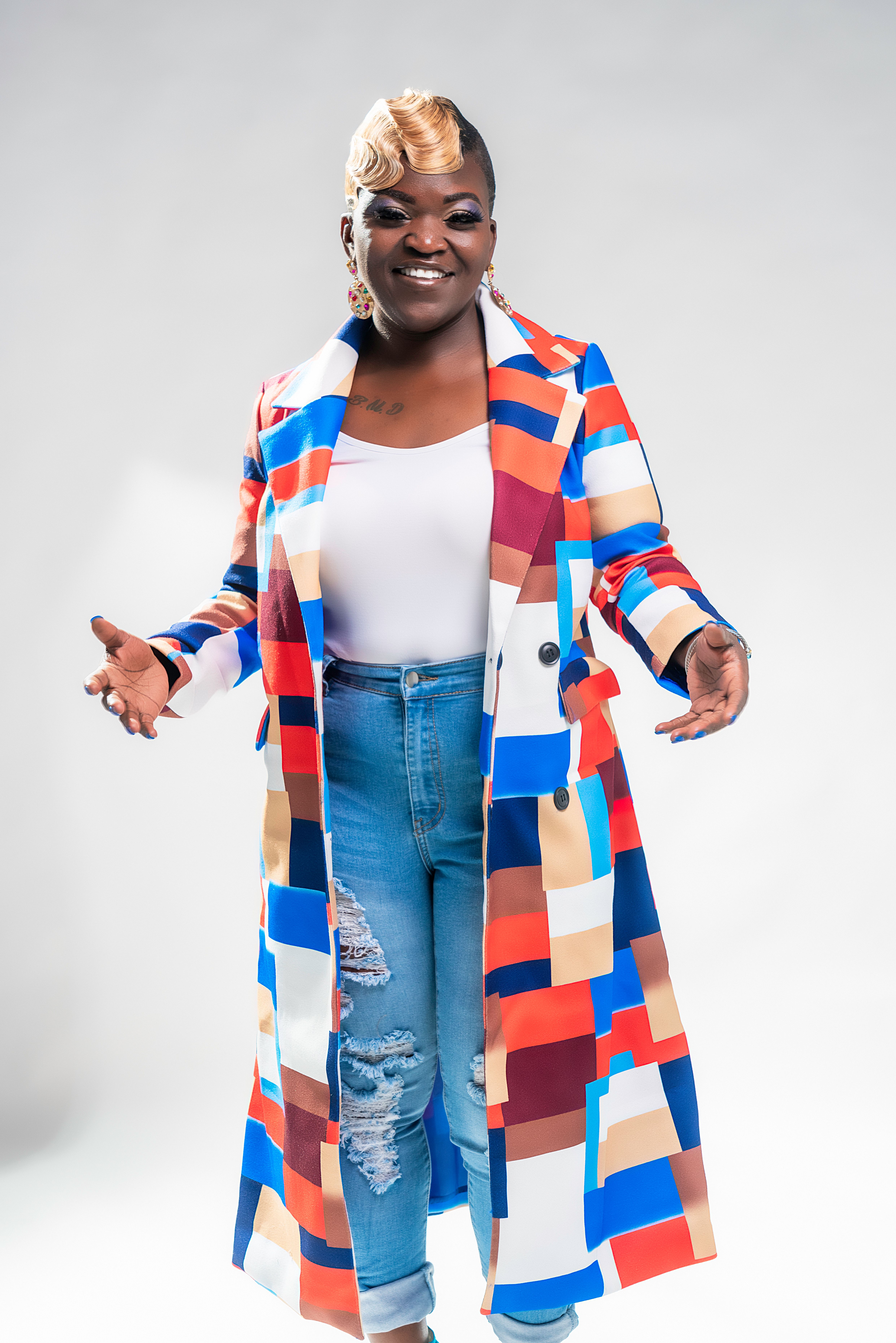 Stylish portrait of an African American woman in colorful attire, photographed indoors in New Orleans.