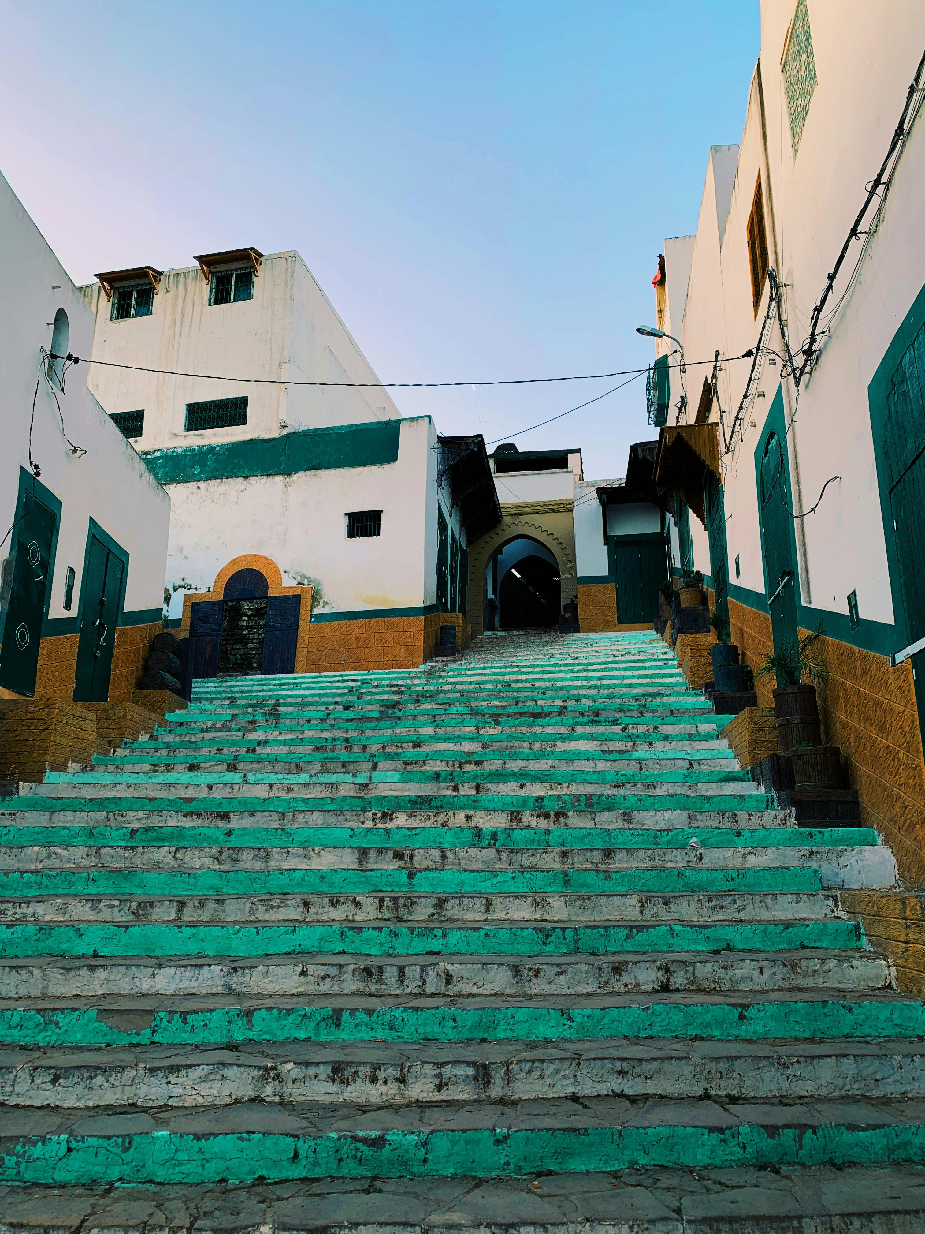 Vibrant steps and traditional architecture in a charming Moroccan alley, showcasing cultural heritage.