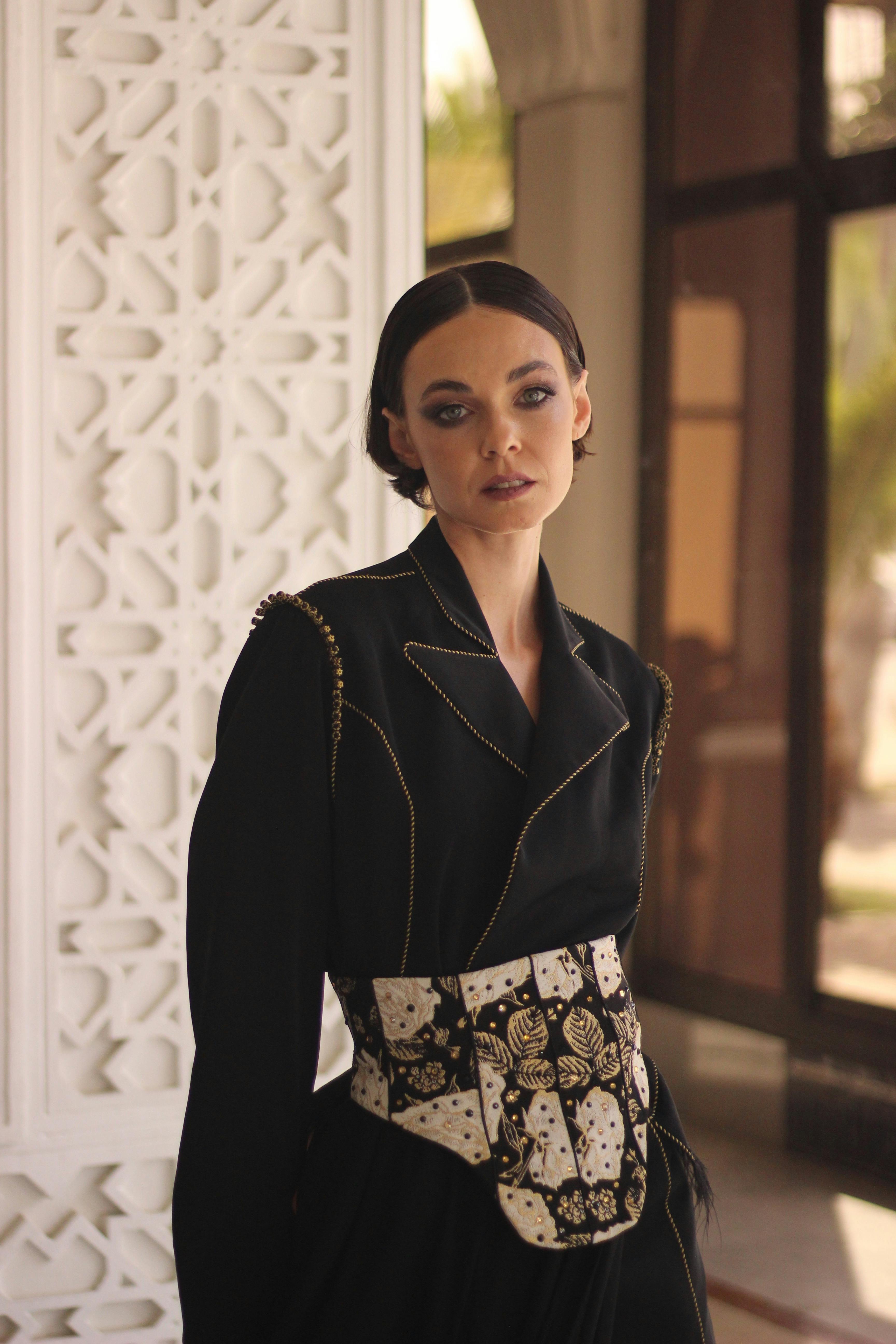 Free Sophisticated portrait of a woman in a stylish black outfit. Marrakesh locale. Stock Photo