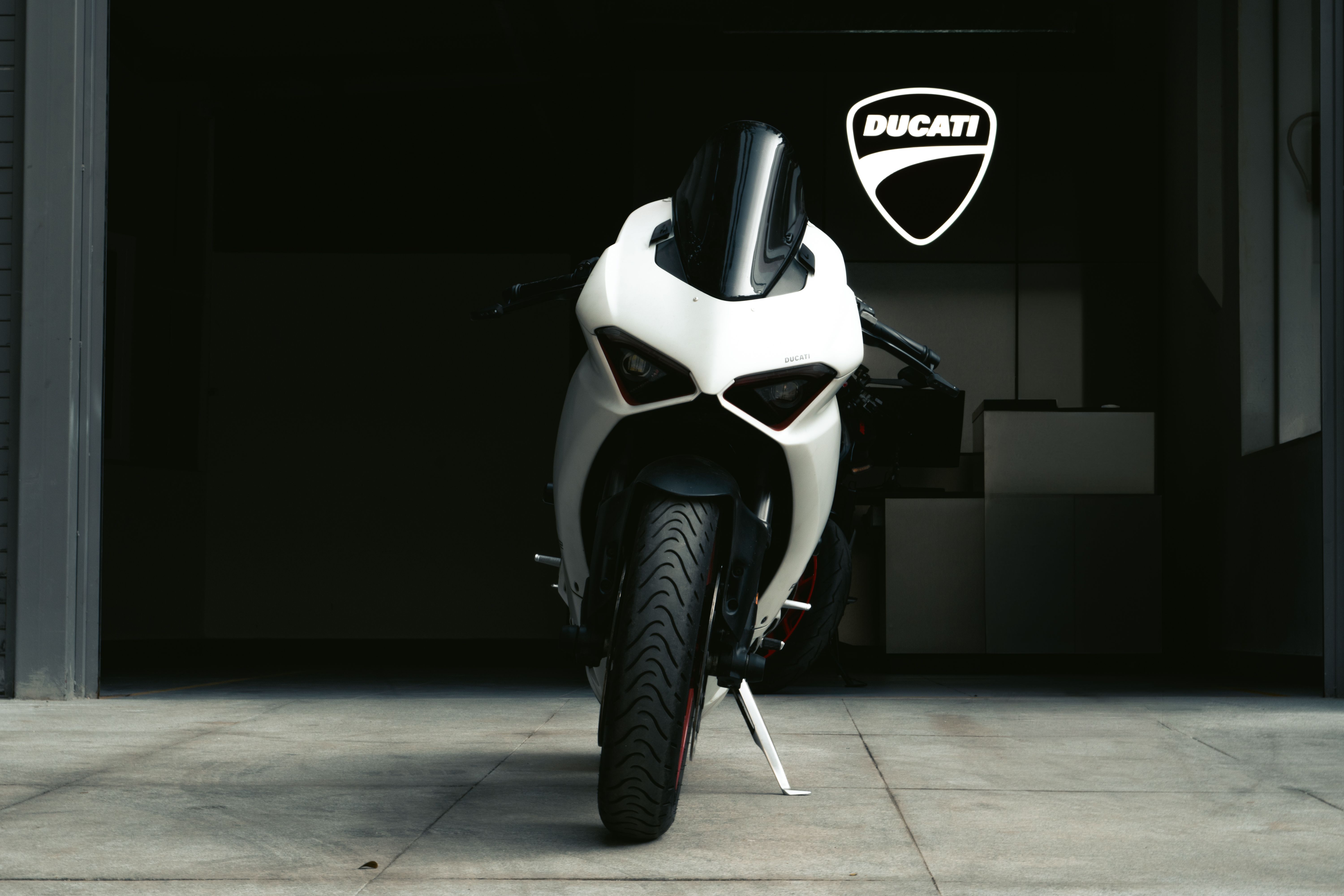 The Centenario showcases its extensive carbon fiber construction and WorldSBK-derived aerodynamics, a testament to Ducati's engineering.