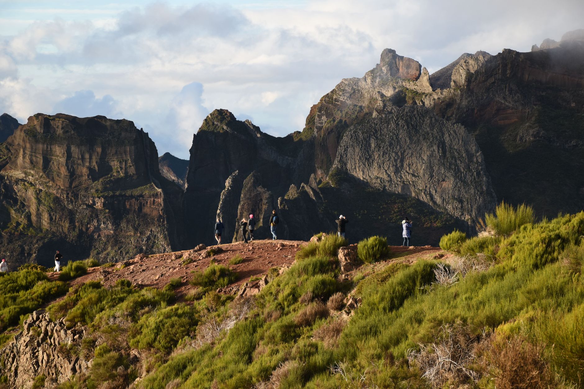 Hikers enjoying a breathtaking view of the Madeira mountains, ideal for tourism and adventure. — photo by Aleksandra S / Pexels