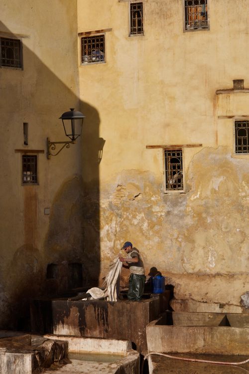 Free A tannery worker processes leather in the historic city of Fes, Morocco. Stock Photo