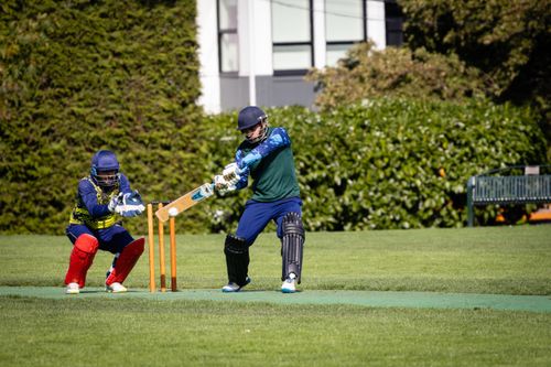 Free A thrilling moment captured during a cricket game with the batter and wicket-keeper in action. Stock Photo