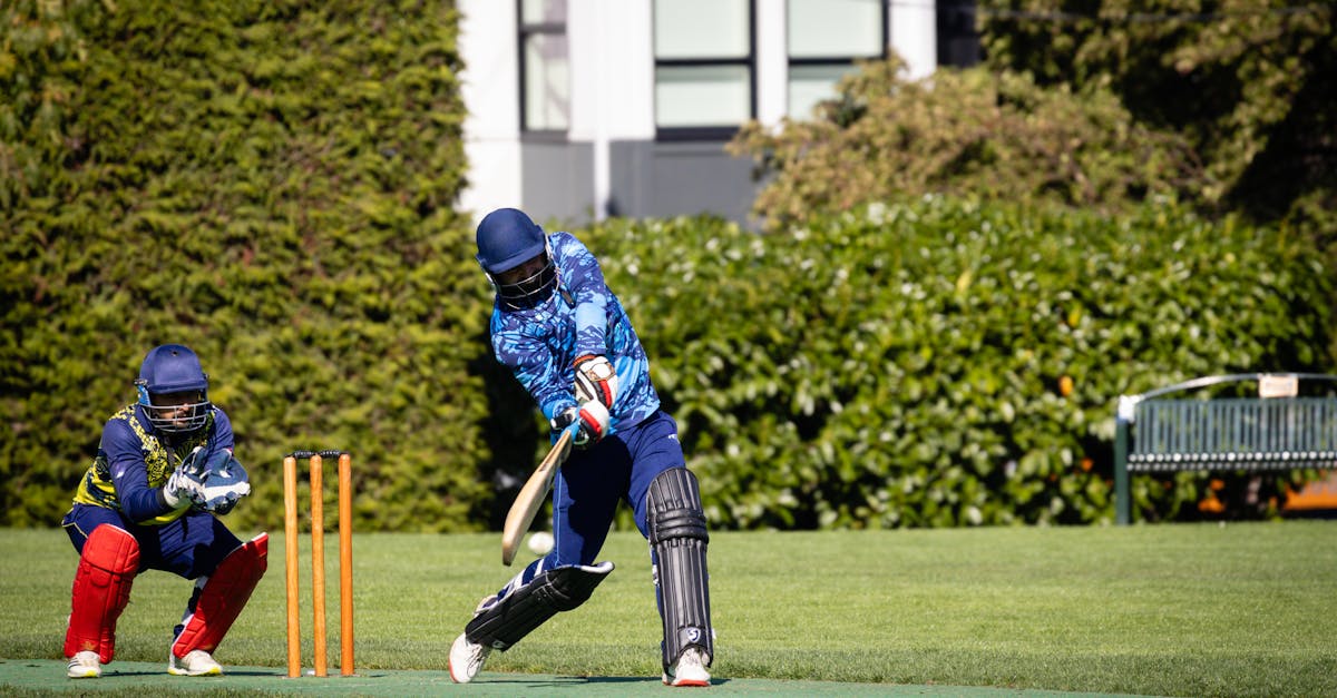 Exciting outdoor cricket match with players in full gear showcasing teamwork and sportsmanship.