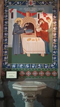 Colorful mural depicting a saintly figure in a church setting with intricate designs and religious symbolism.