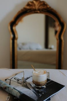 A stylish cappuccino in front of a vintage mirror, capturing a cozy and elegant mood.