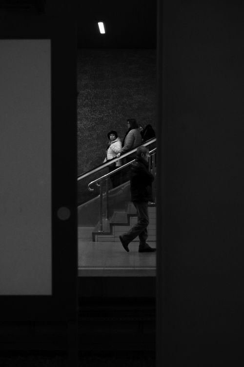 Free Monochrome shot of people on an indoor escalator, creating an urban mood. Stock Photo